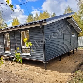 Фасад каркасного дома, обшитый пластиковыми панелями "Блок-хаус"